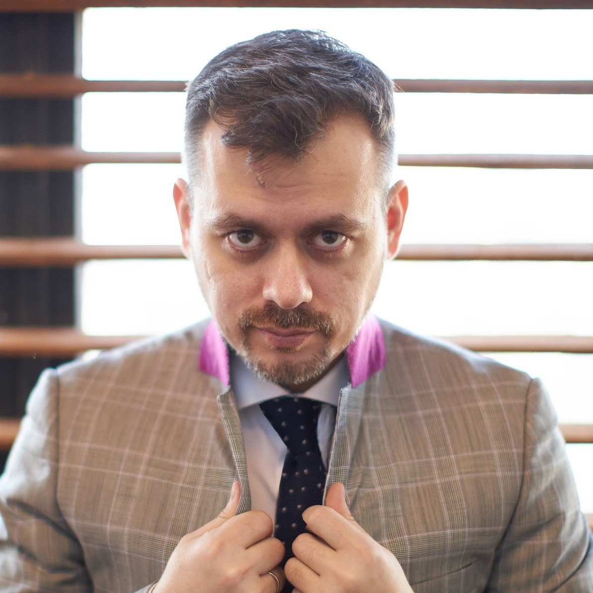 Sergey mustafaev the partner consultant holding his suit while staring at the camera