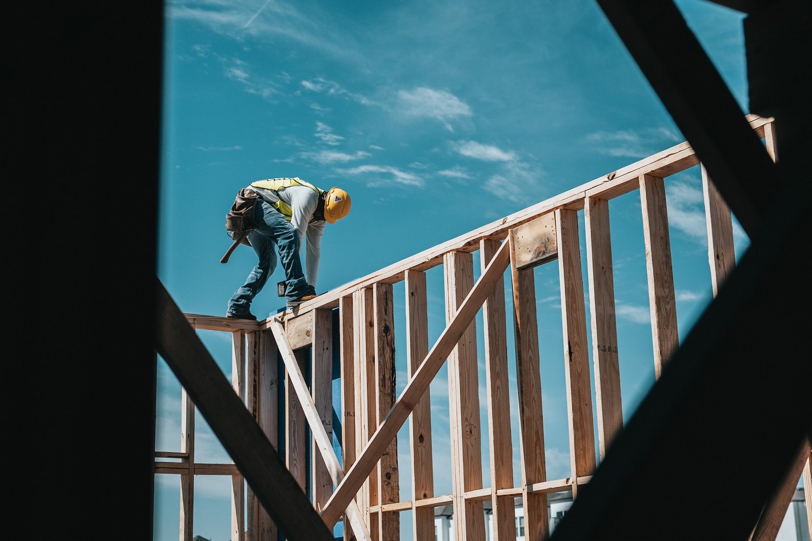 Construction worker on top of wooden structure working